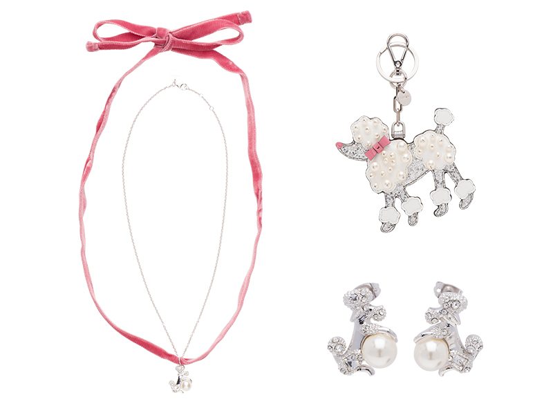 MIU MIU今年特別推出貴婦狗圖案的圖案鑰匙扣、手鍊及耳環，配白色水晶和珍珠項鍊，可愛又不失佻皮。